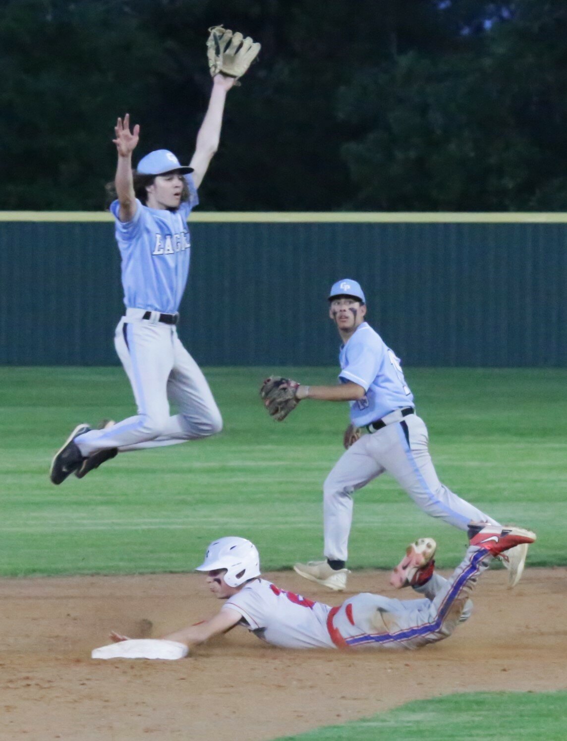 Michael Lacy executes a clean steal of second base while the Como-Pickton throw errantly heads into center field.